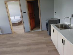a kitchen with a sink and a mirror at Grace Hotel in Honiara +10 photos