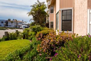 a garden filled with lots of flowers next to a house at Channel Island Shores in Oxnard