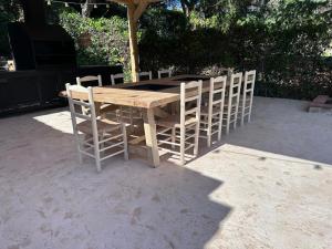 a wooden table and chairs sitting under an umbrella at Villa Costa Brava in Calonge