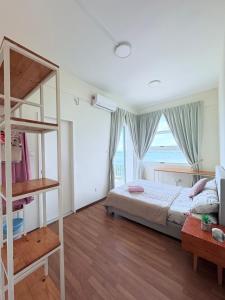 a bedroom with a bunk bed and a large window at Elegant Homestay Borneo Cove in Sandakan