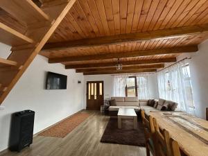 a living room with a couch and a table at Cabana Ilinca in Sălciua de Jos