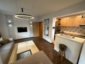 a kitchen and living room with a couch and a table at Kovači Residence in Hrasnica