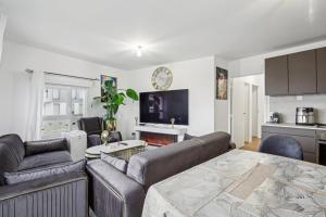 a living room with a couch and a table at Le Havre de Paix in Bezons