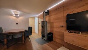 a room with a table and a flat screen tv at Belalp - schöne Ferienwohnung SOLELUNA in Belalp