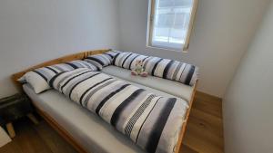 a group of pillows on a bed in a room at Belalp - schöne Ferienwohnung SOLELUNA in Belalp