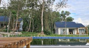 a house with a swimming pool in front of a house at Baisao Villa in Phú Quốc