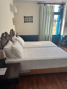 Voodi või voodid majutusasutuse Hotel Aliki toas