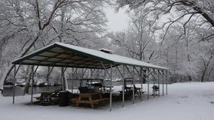 a pavilion with tables and chairs in the snow at Two Rivers Lodge in Bryson City