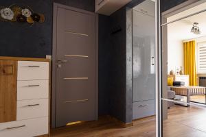 a room with a closet and a glass door at Mieszkanie Giżycko in Giżycko