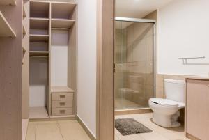 a bathroom with a toilet and a walk in shower at Boutique Apartament Carso Alameda-1002 in Mexico City +12 photos
