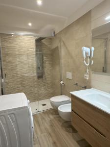 a bathroom with a toilet and a sink and a tub at ZIO PEPPE in Senise
