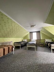 a room with two beds and a couch at Аренда Дома in Karakol