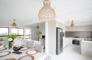 a kitchen and living room with a table and chairs at The Green Dragon in Gerroa