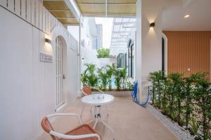 a hallway with a table and chairs in a building at Ayas Retreat - Muji Ekkamai Pool Villa with 4 bedrooms in Khlong Toei