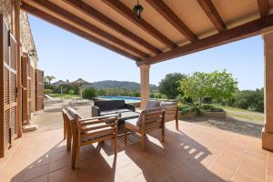 an outdoor patio with two chairs and a table at Cas Batlet in S'Horta