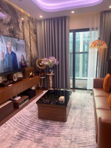 a living room with a couch and a tv at 7Homestay in Hai Phong