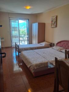 a hotel room with two beds and a balcony at Sea View in Tivat