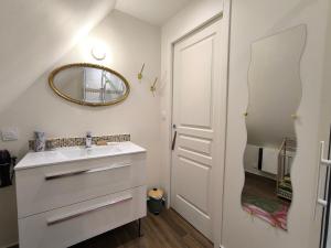 a bathroom with a sink and a mirror at Dodo et tartines The10-12 in Bayeux +11 photos