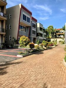 a brick driveway in front of a building at Yazmin's Bright Studio with Fast Wi-Fi & Parking in Kampala