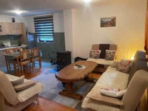 a living room with a table and chairs and a kitchen at Villa Enigma in Bihać