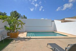 a swimming pool in the backyard of a house at Rufo - Casablanca House in Alcudia