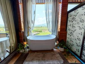 a bath tub in a bathroom with a window at บ้านฮิมนาปัวรีสอร์ท in Pua +123 photos