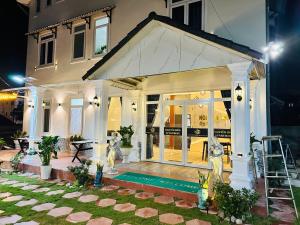 a house with a front porch with a ladder at Dalat Hills Apartment in Da Lat
