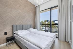 Posteľ alebo postele v izbe v ubytovaní Shellter Apartments 117 Ł - by Jantar Apartamenty