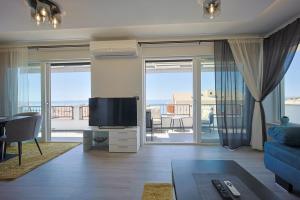 TV a/nebo společenská místnost v ubytování La Storia Apartments