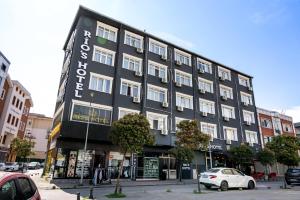 a black building with a sign on the side of it at RİO's HOTEL KURTKÖY in Istanbul