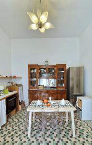 a kitchen with a table and a ceiling fan at MandorleOlio in Polignano a Mare