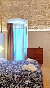 a bedroom with a bed with two towels on it at MandorleOlio in Polignano a Mare