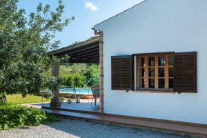 a house with a window and a patio at Can Amer in Pollença