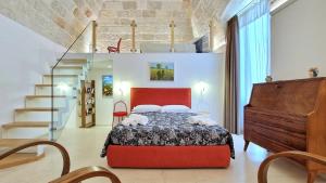a bedroom with a bed and a staircase at MandorleOlio in Polignano a Mare