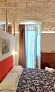 a bedroom with a bed and a window at MandorleOlio in Polignano a Mare