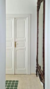an open door in a room with a mirror at MandorleOlio in Polignano a Mare