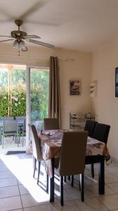 a dining room with a table and chairs at MAS Élancia in Argelès-sur-Mer