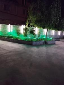 a fence with green lights on it at night at Zețarilor 21A in Bucharest