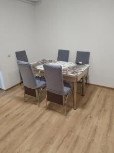 a dining room table with four chairs around it at Zețarilor 21A in Bucharest +4 photos