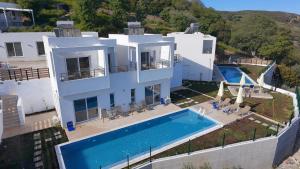 an aerial view of a house with a swimming pool at Kandania Paradise in Kántanos