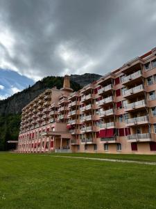 a large building with a grass field in front of it at Mont Blanc view on a 40m2 Terrace in Passy