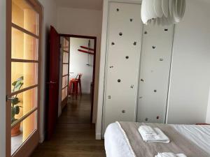 a bedroom with a bed and a door to a hallway at Mont Blanc view on a 40m2 Terrace in Passy
