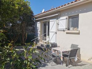 a patio with a table and chairs next to a house at U Casetta in Patrimonio
