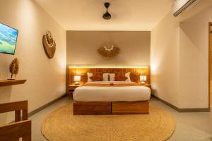 a bedroom with a large bed and a rug at Villa Baliga Ubud by BaliSuperHost in Ubud