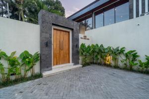 a wooden door on the side of a building at Villa Baliga Ubud by BaliSuperHost in Ubud