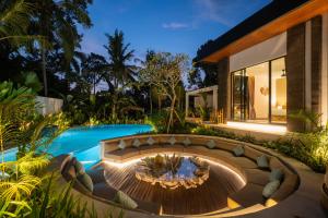 a backyard with a fire pit and a swimming pool at Villa Baliga Ubud by BaliSuperHost in Ubud