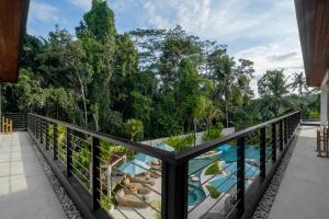 a balcony with a view of a pool at Villa Baliga Ubud by BaliSuperHost in Ubud