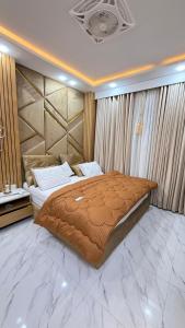 a bedroom with a large bed in a room with marble floors at ParkView City Lake Facing in Malot