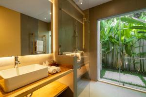a bathroom with a sink and a large window at Villa Baliga Ubud by BaliSuperHost in Ubud