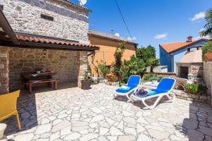 een patio met 2 stoelen en een tafel bij St. Bernhard House in Funtana